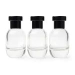 kemasan botol parfum spray TELUR BLACK varian warna bening transparan dengan cap hitam