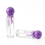 kemasan kosmetik BOTTLE LIP D623 varian warna bening transparan dengan cap ungu