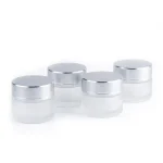 kemasan kosmetik POT FROSTED CAP SILVER KACA varian warna bening frosted dengan cap silver metalik
